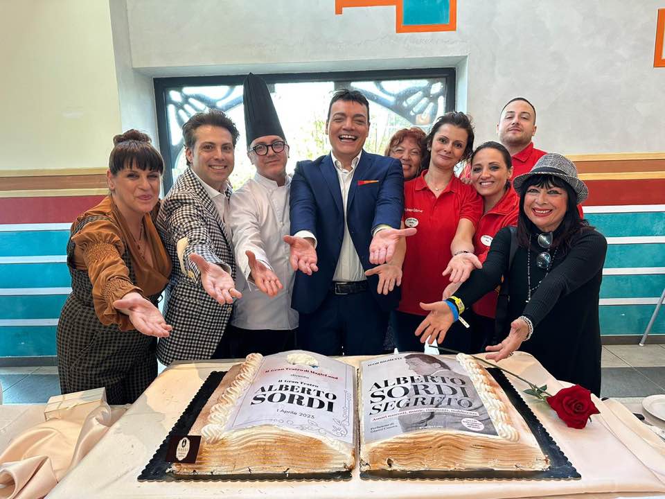 Davanti alla torta artistica con la copertina del libro Alberto Sordi segreto